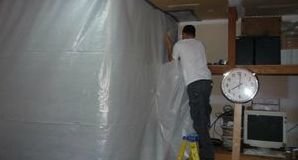 Water and Mold Damage Restoration Tech Using A Vapor Barrier