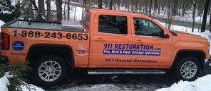 Storm Damage Restoration Vehicle At Job Site